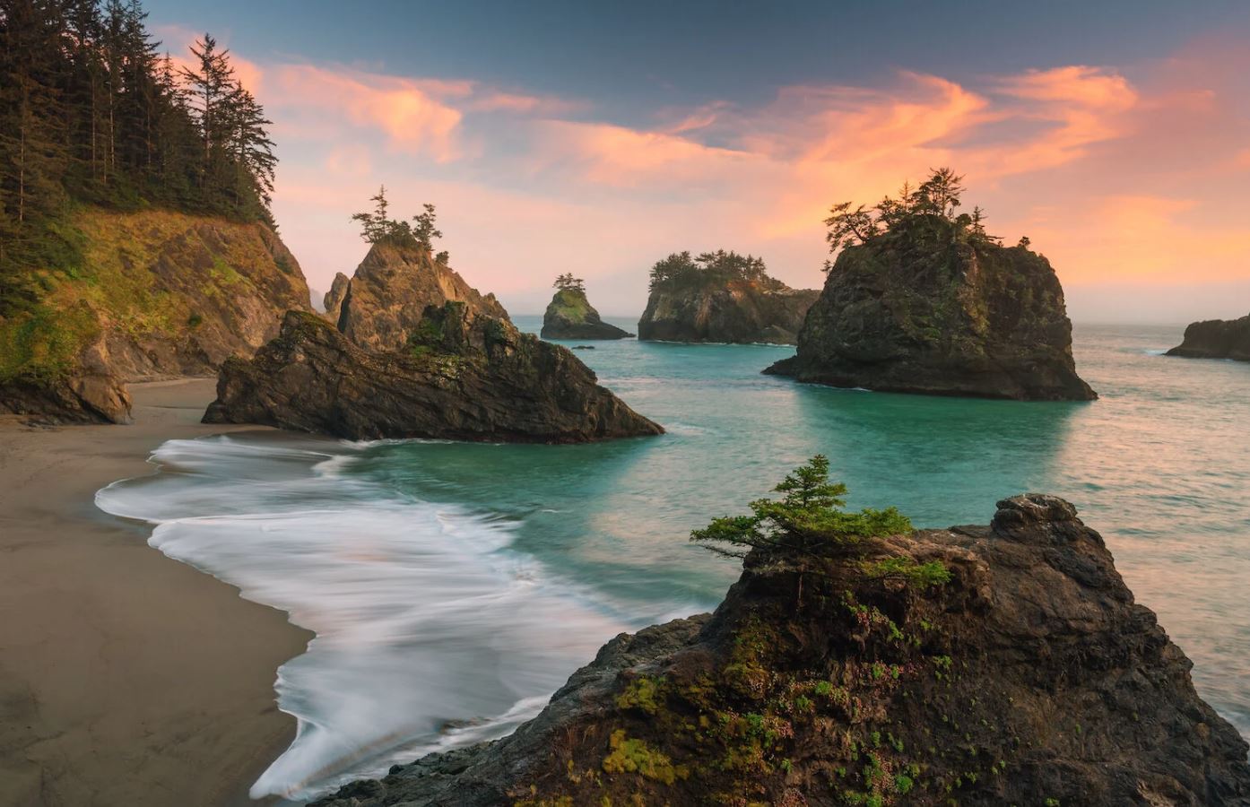 Coastal lighthouse at dusk with soft mist.