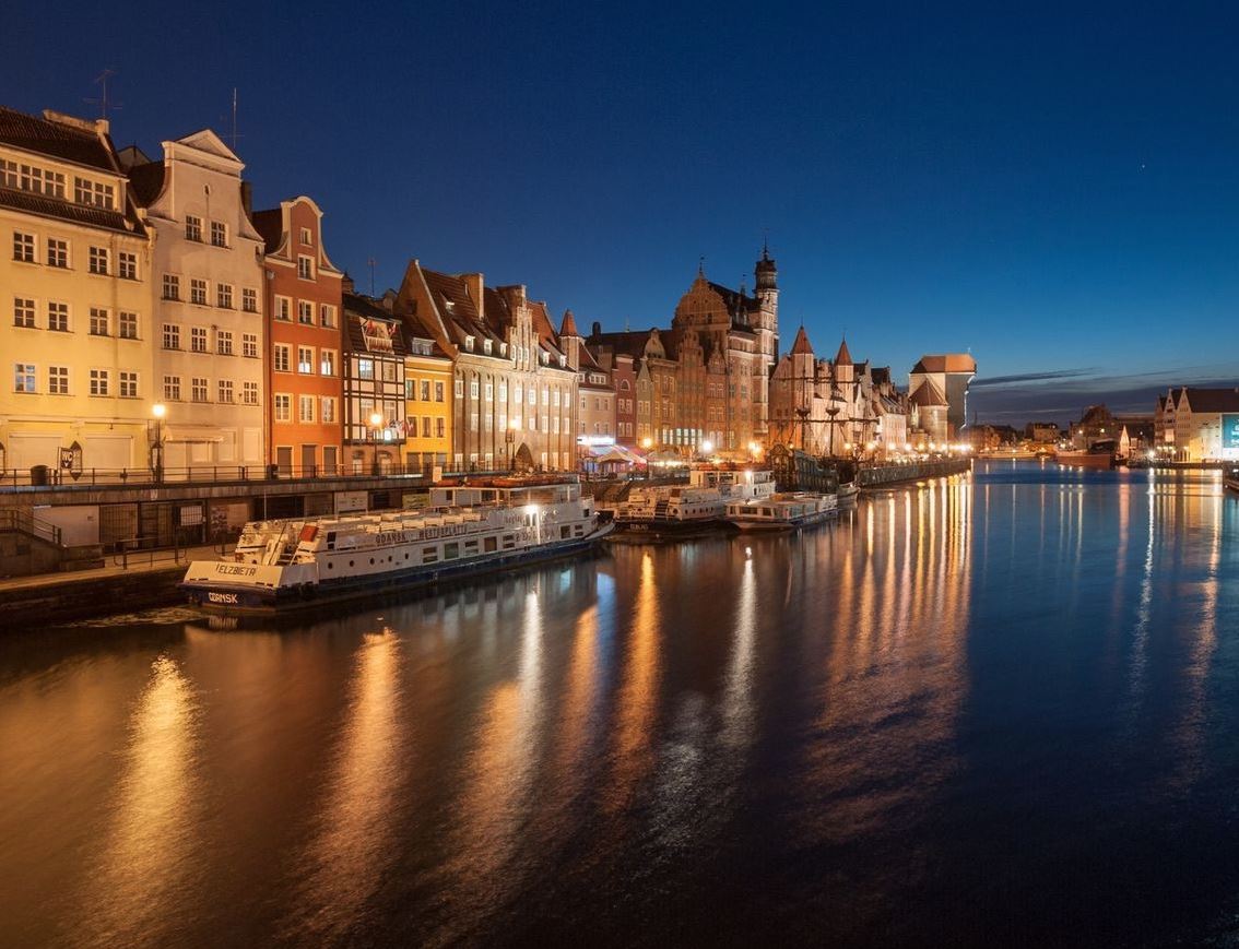 Lighthouse beam cutting across a moonlit coast.